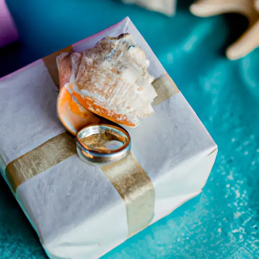 An image showcasing a beautifully wrapped package containing a pair of intricately designed traditional wedding rings, nestled atop a stunning seashell, symbolizing the perfect gift for a destination wedding