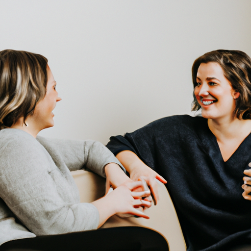An image of two people sitting face-to-face on a cozy couch, engaged in open conversation, with warm smiles and relaxed body language